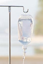 Intravenous Immune bag hanging from a metal stand. Our Edmonton Naturopaths use various intravenous treatments to boost your immune system.